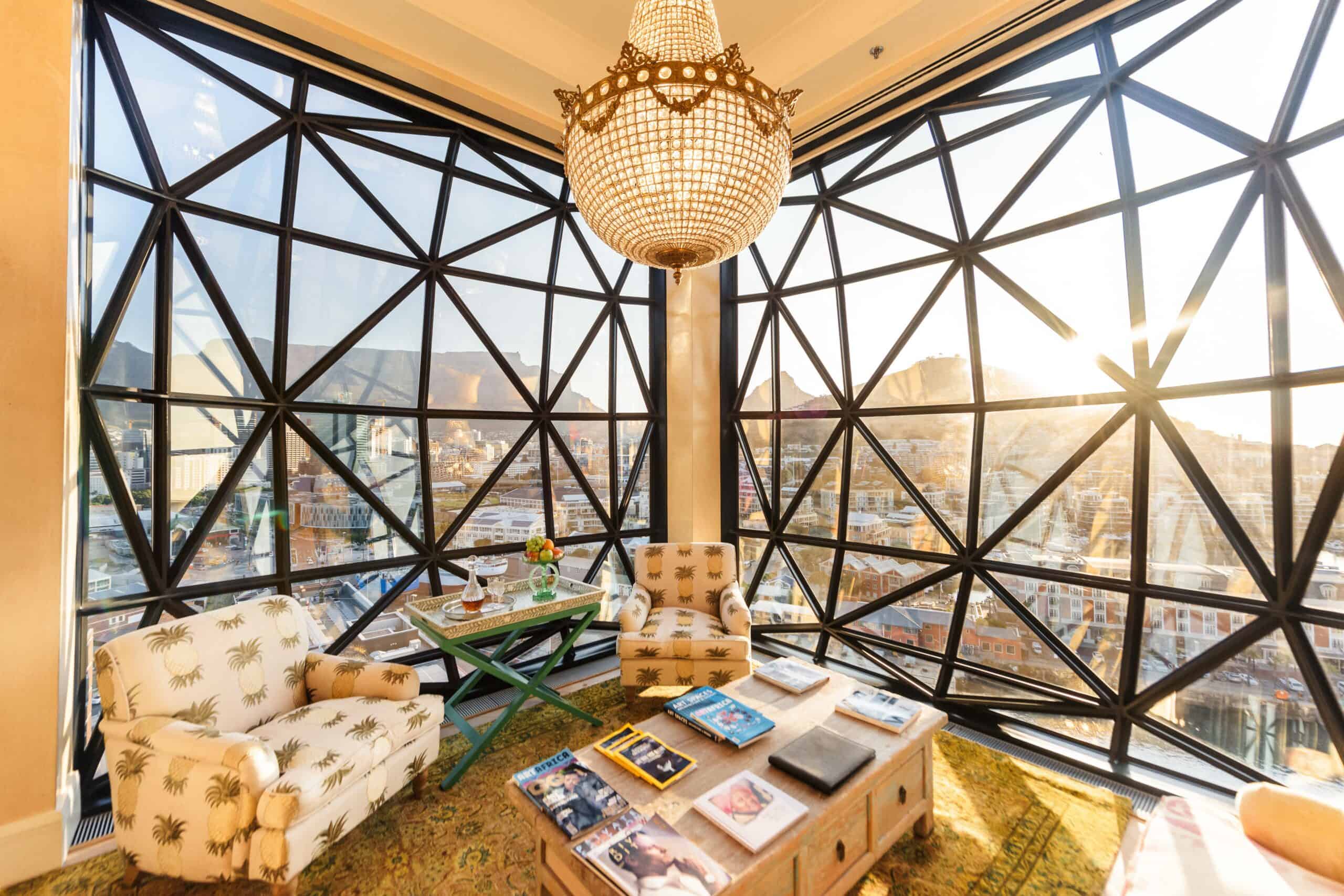 A corner of The Silo with a beaded chandelier hanging in front of the iconic faceted bubble windows overlooking Table Mountain