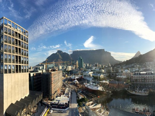 View from a Silo Hotel room out through the faceted bubble windows over the V&A Waterfront toward Table Mountain
