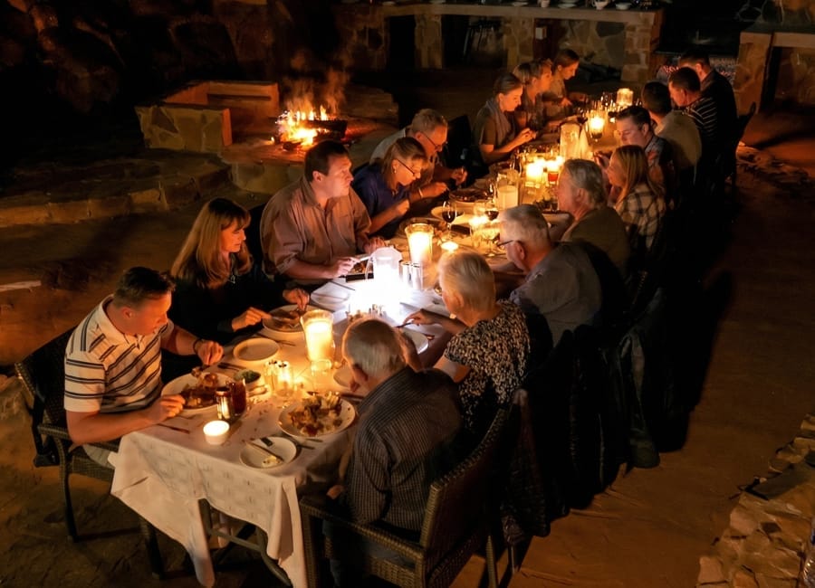 Candlelit bush braai dinner table set up under the African night sky